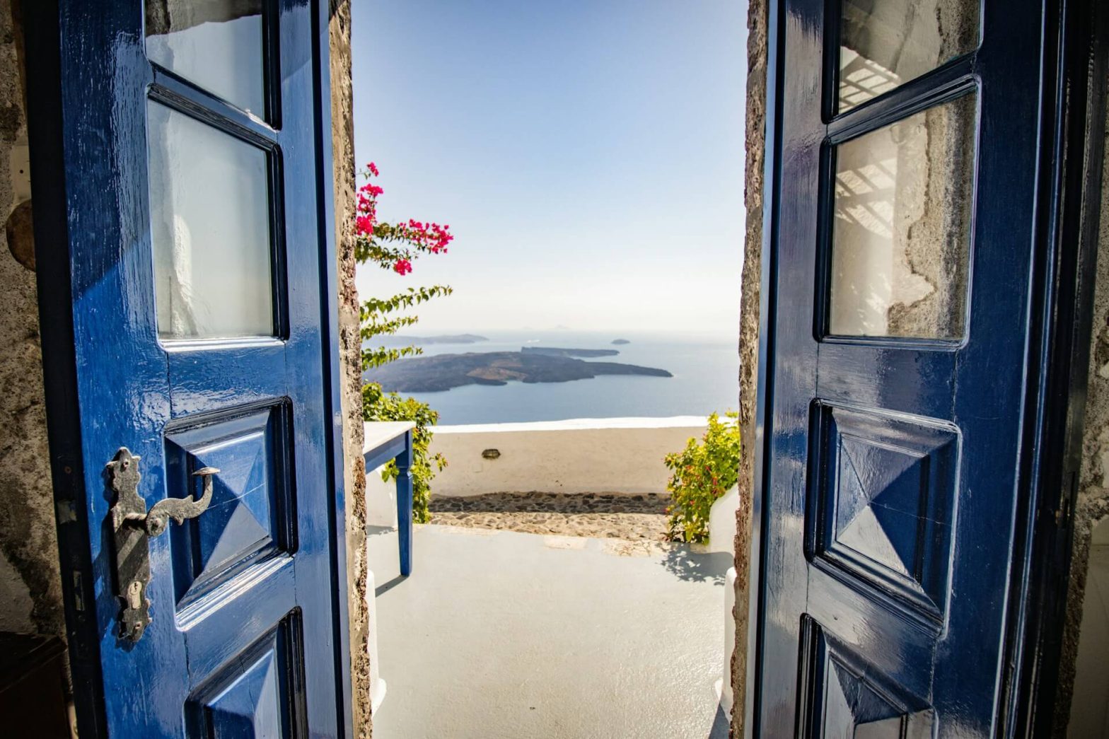 blue doors that are open to reveal the caldera view