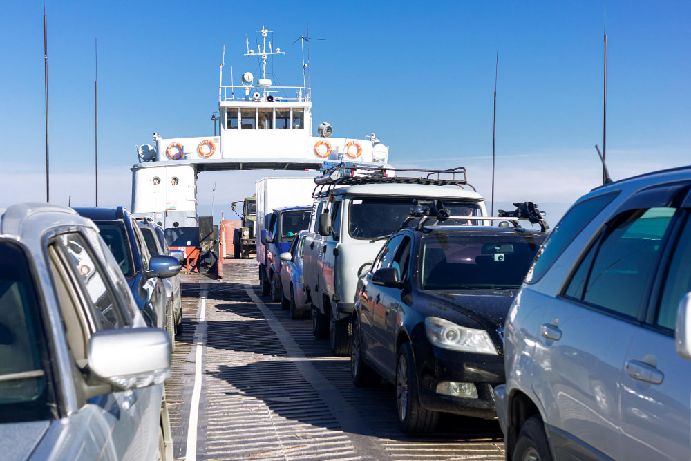 Cars lined up on the deck of a ferry, ready for transport across a body of water