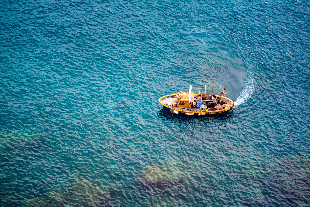 Greek fishing boat on blue water