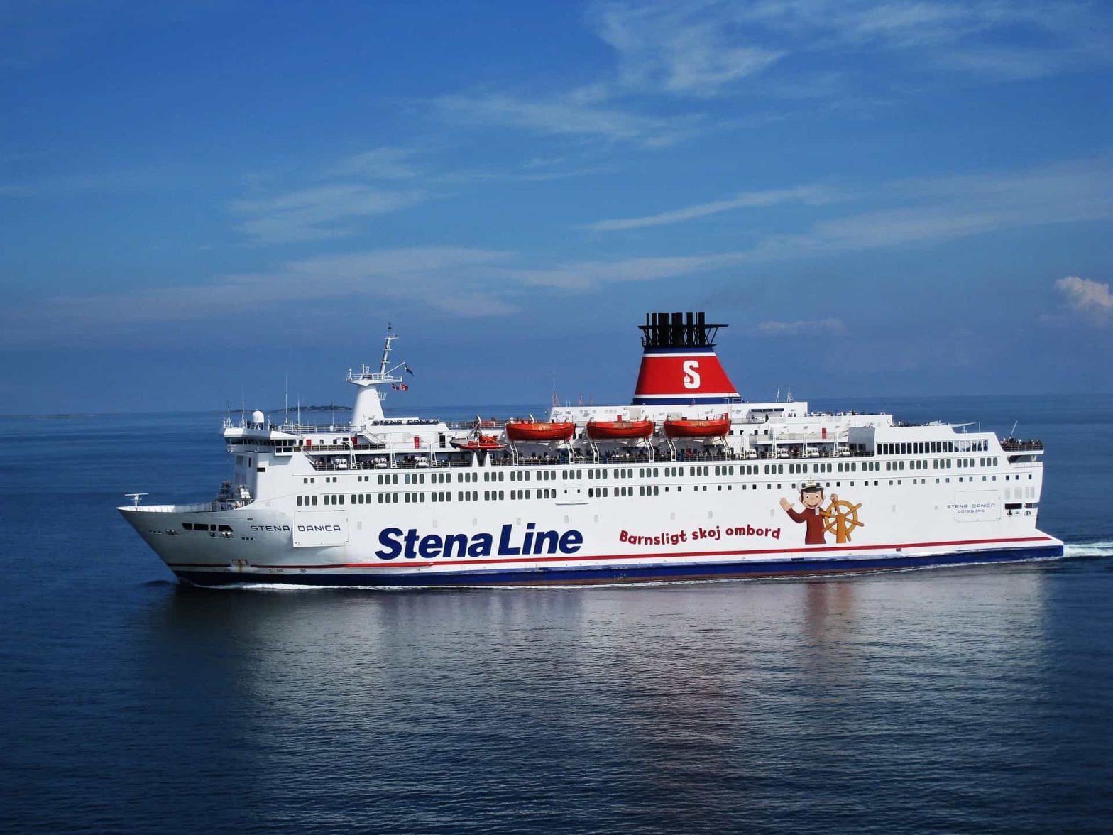 A large Stena Line ferry, named Stena Danica, sailing on calm, open waters