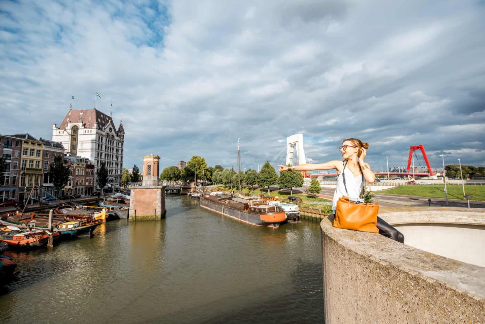 Young woman tourist traveling near the old harbor in Rotterdam city