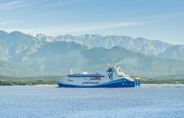 A ferry from La Méridionale gliding across calm, clear waters