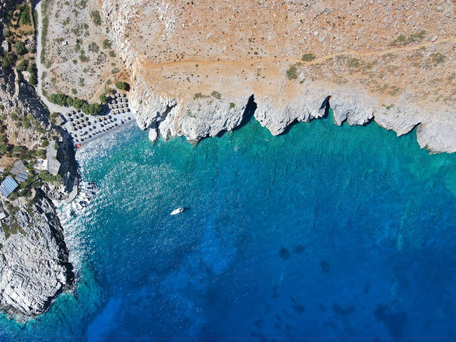 A look at the rocks and bright blue water of Sfakia, Crete from above.
