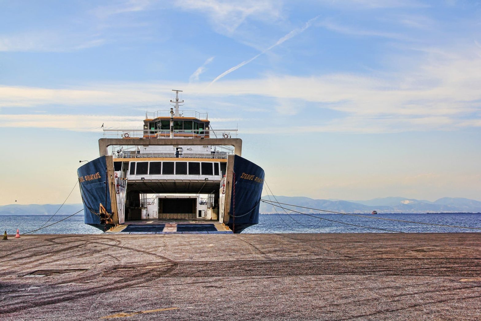 A Morocco to Spain ferry docked at the port, with its open ramp ready for boarding.