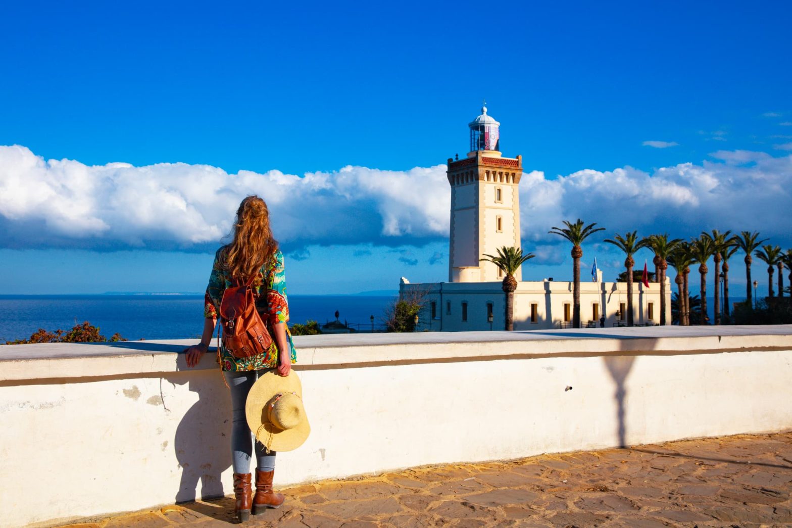 Woman tourist looking at lighthouse of Cap Spartel, Tanger, Morocco in Africa