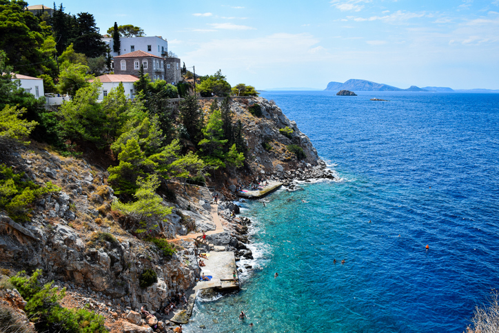 Idyllic summer vibes day in Hydra, Greece a peaceful island in the Saronic Gulf. crystal clear Aegean Sea, surrounded by sunlit stone houses, rocky coastlines, and vibrant Mediterranean charm. A perfect Greek island escape.