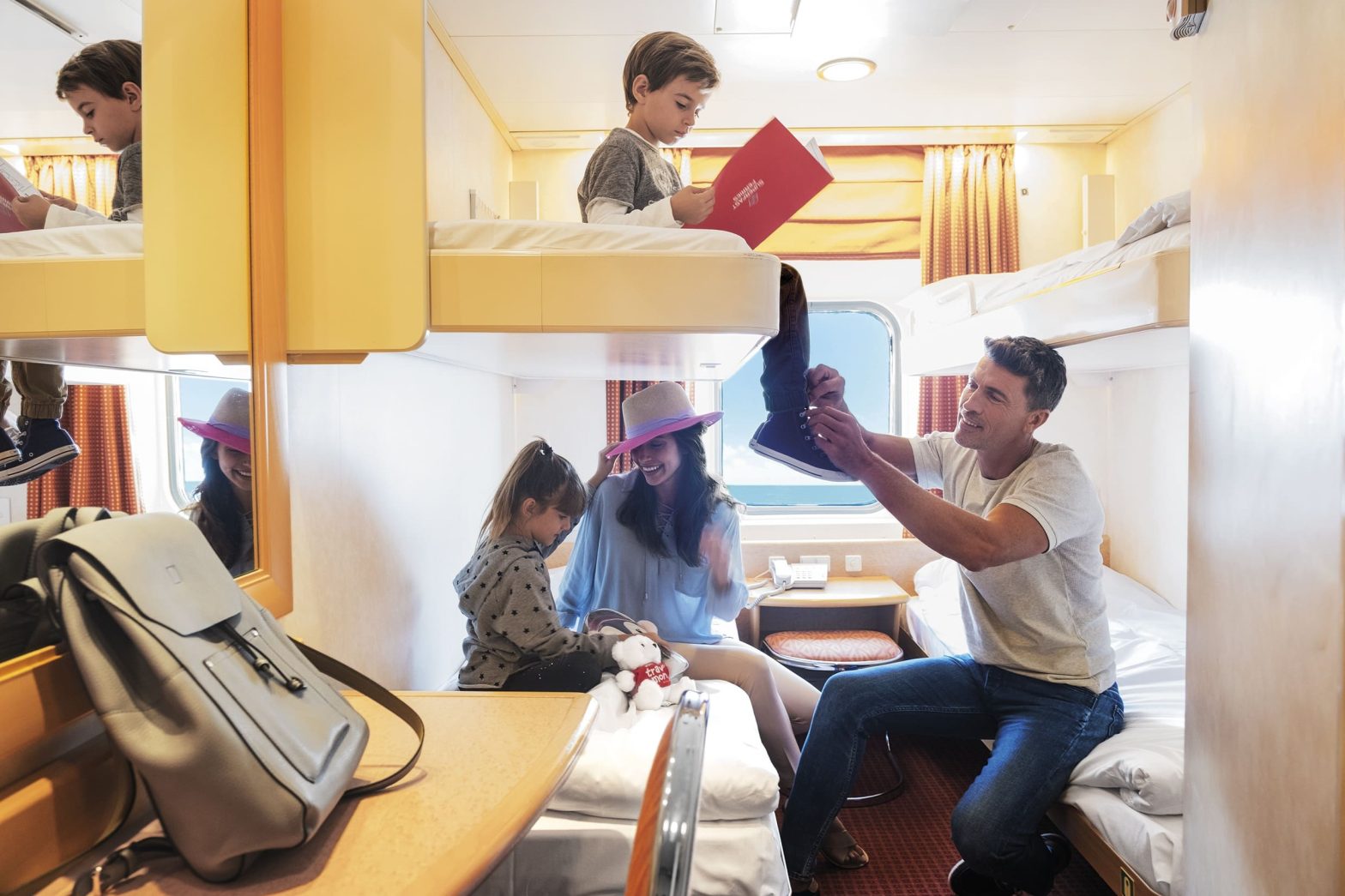 Mom, dad, young son and daughter in a ferry cabin in a Superfast Ferries vessel.